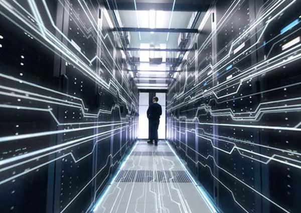 Man walking in aisle of server room