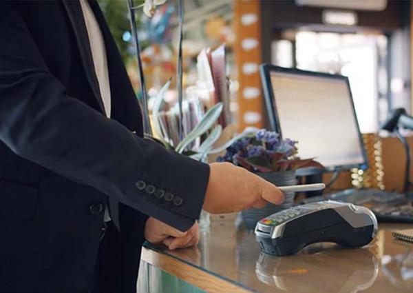 Man pays via payment terminal with mobile phone