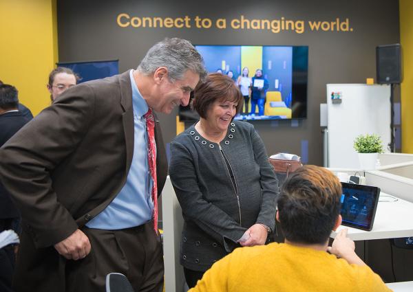 Man and woman looking at tech demo on tablet