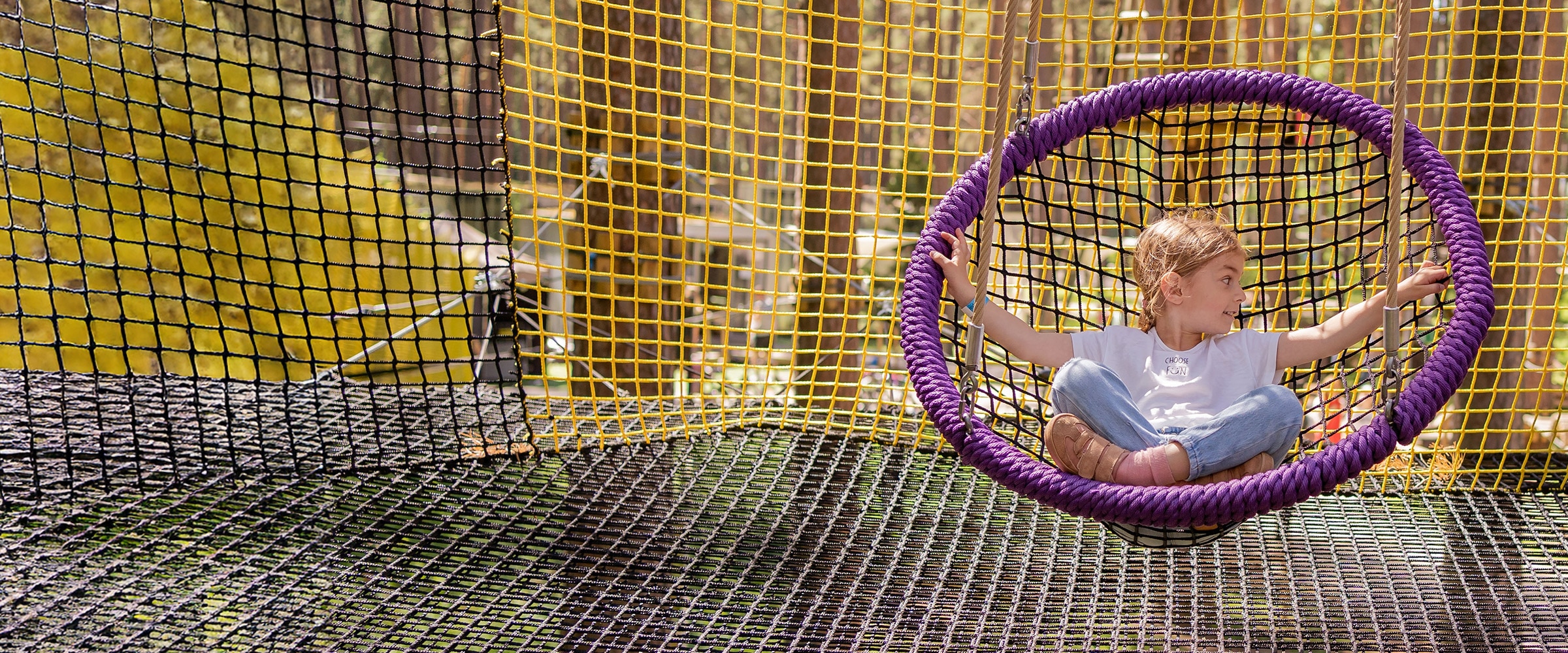 Photo of young girl in a net like swing.