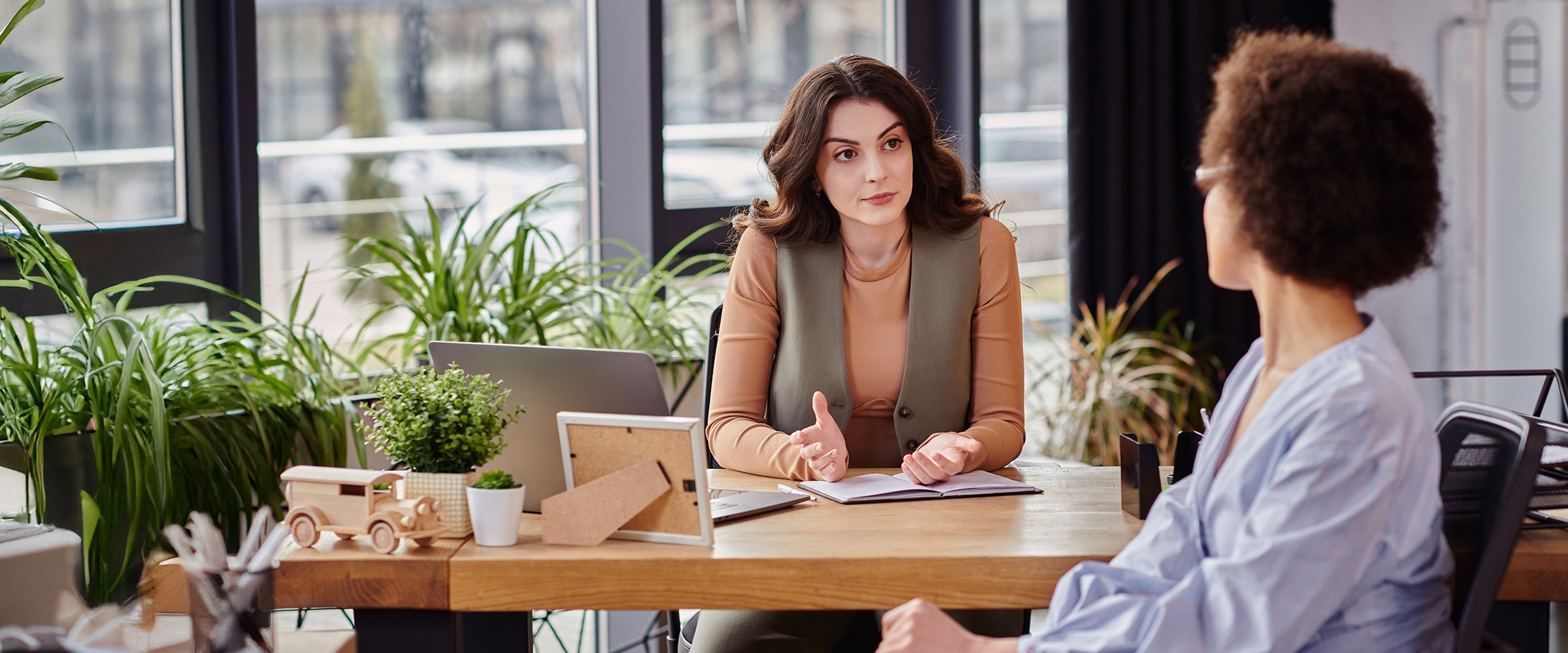 Employee at boss' desk having a serious talk.
