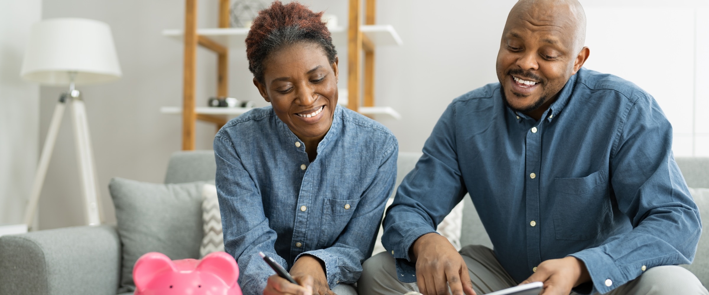 Photo of couple in matching blue shirts looking at finances