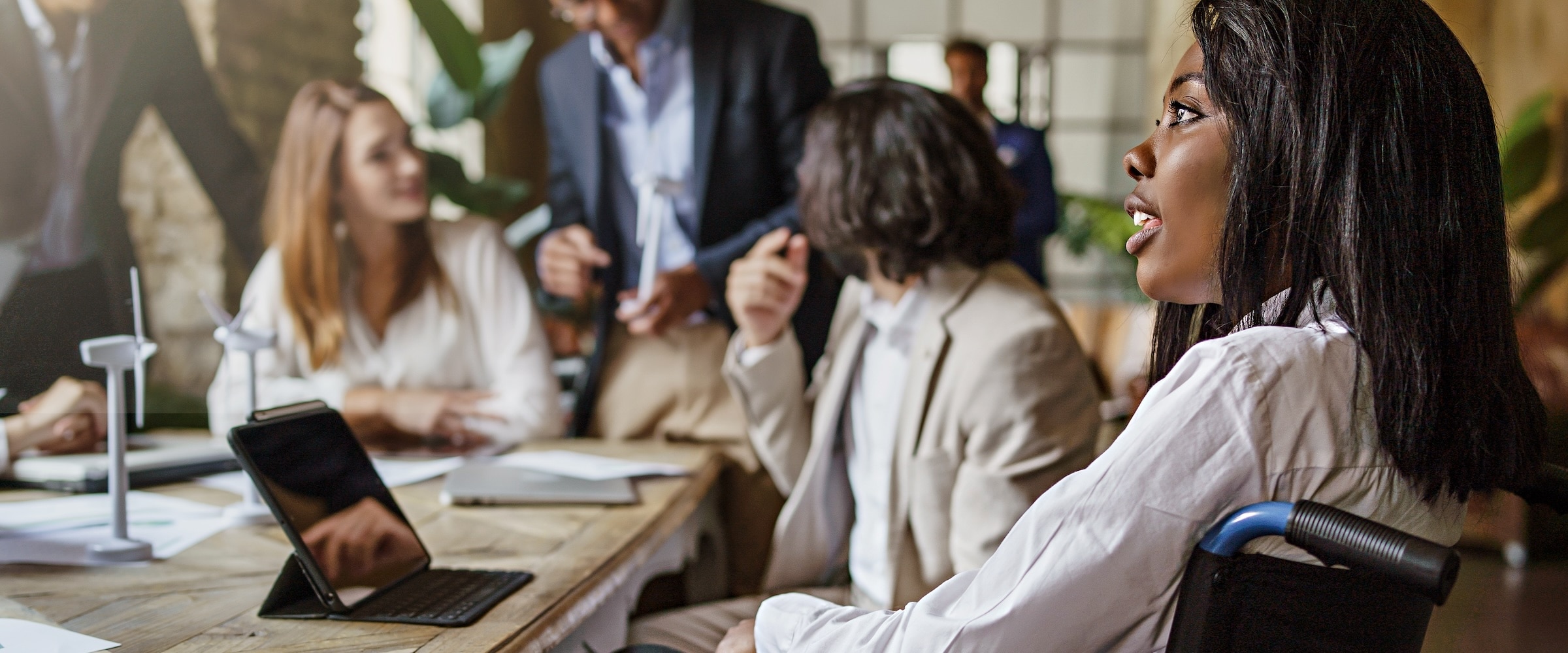 Photo of a African-american woman in wheelchair at a business meeting.
