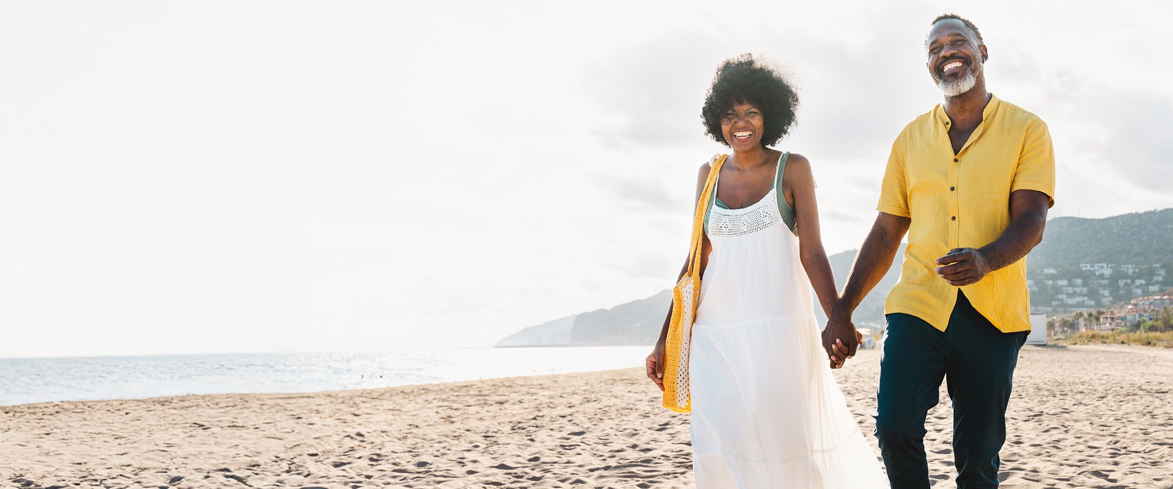 African-american couple walking on a beach.