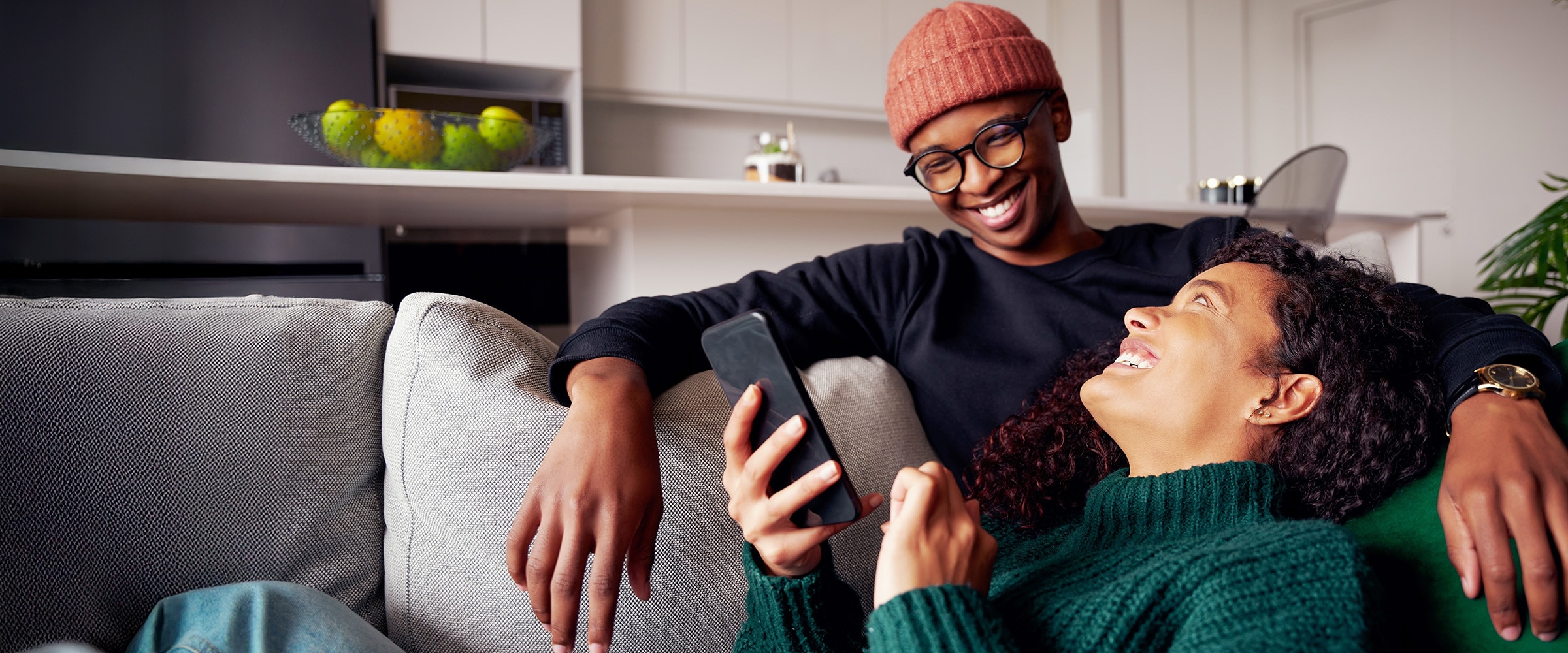Photo of couple resting with each other on the couch.