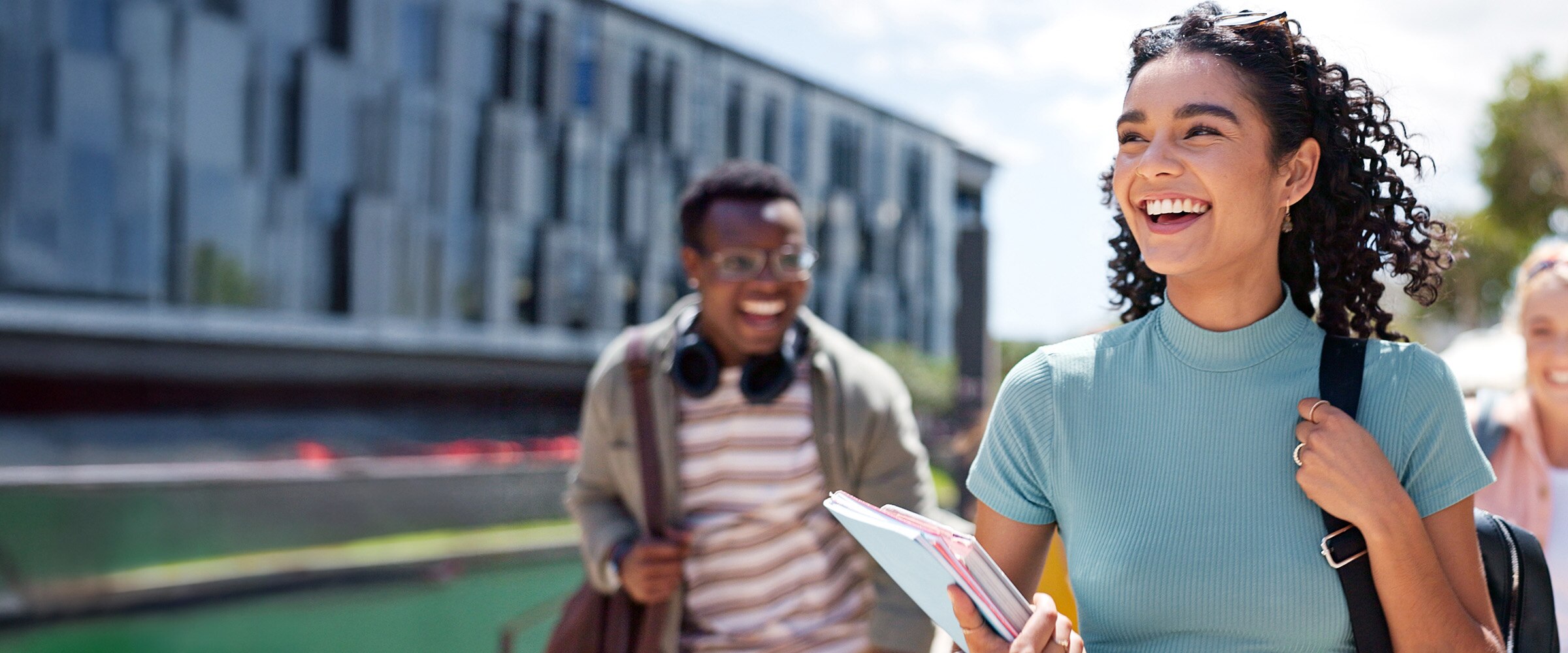 Photo of college student walking past a school business.