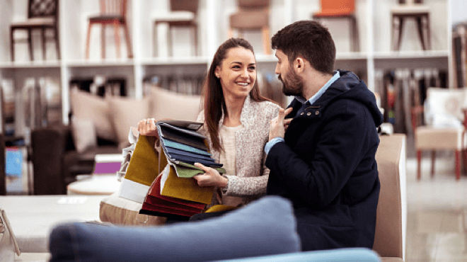 A Couple looking at fabric samples at furniture store
